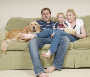 Young family on couch after upholstery cleaning